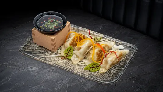 Pan-fried dumplings filled with chicken, cabbage & spring onion. — delivery in Cranham RM14