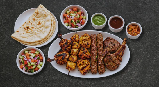 Chicken lollipop, chicken tikka boti, tandoori chicken, seekh kebab and lamb chops with naan, kachumber salad & chutneys.