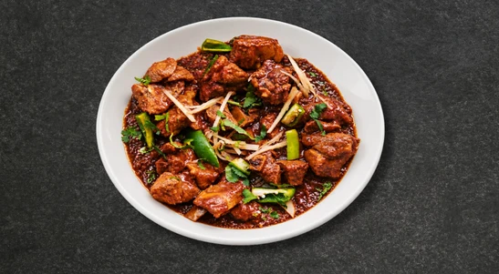 Spring chicken cooked on the bone in the traditional style with ginger, garlic, black pepper & fresh tomatoes. Topped with