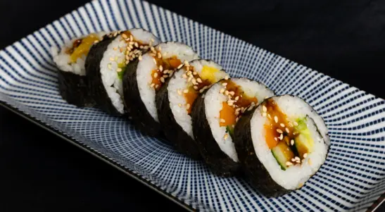 A fresh oversized vegan roll filled with mango, cucumber & avocado with teriyaki glaze & sesame. — delivery in Bletchley MK3