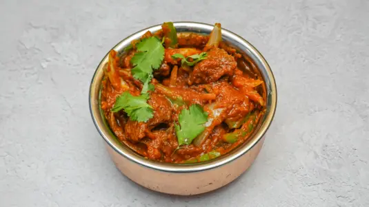 Medium spicy mutton curry cooked with house blended spices and fresh salad — delivery in Bellingham SE6